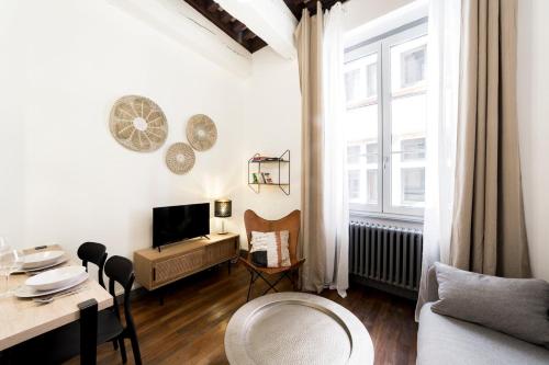 un salon avec un canapé, une table et une télévision dans l'établissement Spacious and cozy in Vieux Lyon AIL, à Lyon
