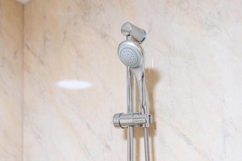 a shower head on a wall in a bathroom at Stourbridge 2 Bedroom Apartment - Netflix & WIFI - Parking - Top Rated - 1CS in Amblecote