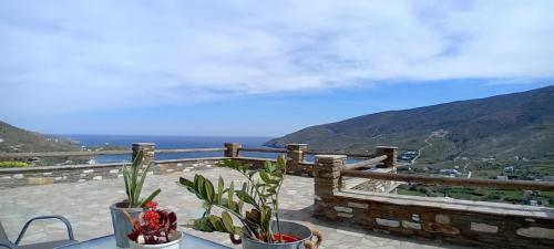 a balcony with a view of the ocean and mountains at Liopi Village Andros in Órmos