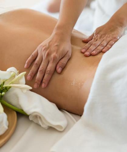 a woman getting a massage in a bed with flowers at Hotel La Villa Saint Germain Des Prés in Paris