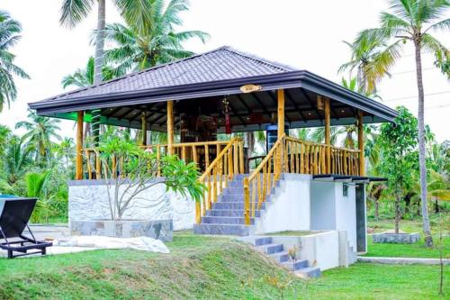 a gazebo with a staircase in a park at Liverpool Estate - Chilaw in Chilaw