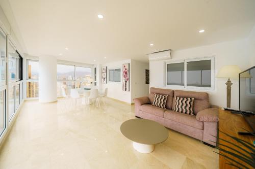 a living room with a couch and a table at Santa Margarita - Benisun in Benidorm