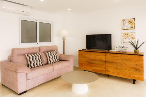 a living room with a couch and a tv at Santa Margarita - Benisun in Benidorm
