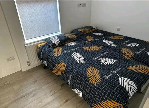 a bedroom with a bed and two pillows on it at Second Av flat 4 Hendon London in Hendon