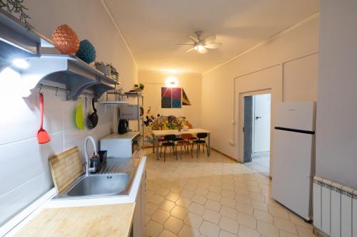 a kitchen with a sink and a refrigerator at Naples Pizza Hostel in Naples
