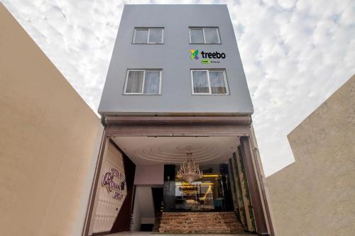 a white building with a chandelier in front of it at Treebo Trend Taj Dream Agra in Agra