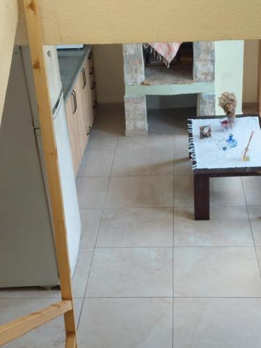 a living room with a tile floor and a table at Daphne Pansiyon in Bergama