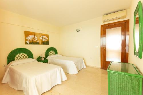 a room with two beds in a room at Santa Margarita - Benisun in Benidorm