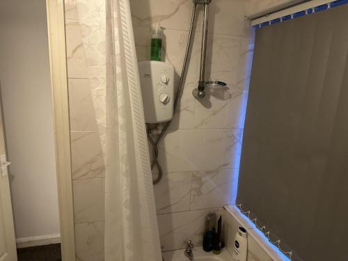 a bathroom with a shower with a shower curtain at Beautiful 1-Bed House in Bradford in Bradford