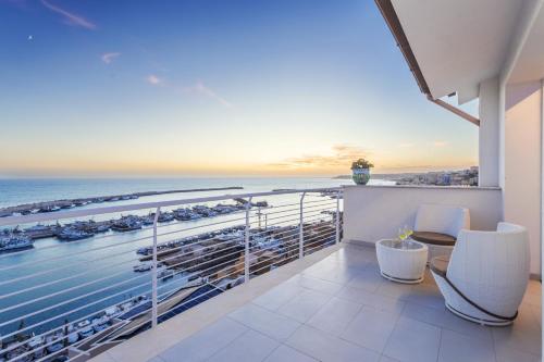 a balcony with a view of the ocean at Hibrido Boutique Hotel & Spa in Sciacca