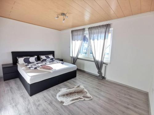 ein Schlafzimmer mit einem Bett und einem großen Fenster in der Unterkunft Ferienwohnung in Diemelsee in Diemelsee