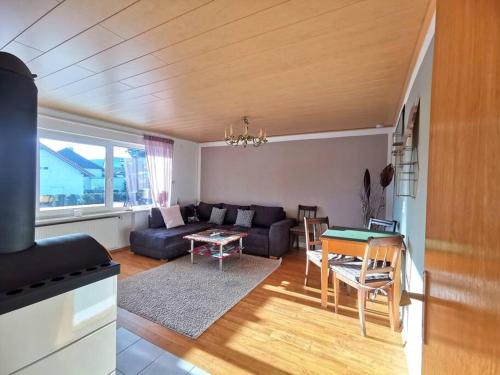 ein Wohnzimmer mit einem Sofa und einem Tisch in der Unterkunft Ferienwohnung in Diemelsee in Diemelsee