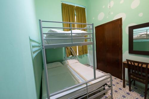 a bunk bed in a room with a bunk bedscribed at Naples Pizza Hostel in Naples