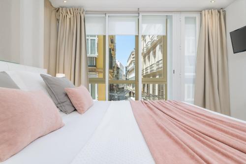 En eller flere senge i et værelse på iloftmalaga City Center