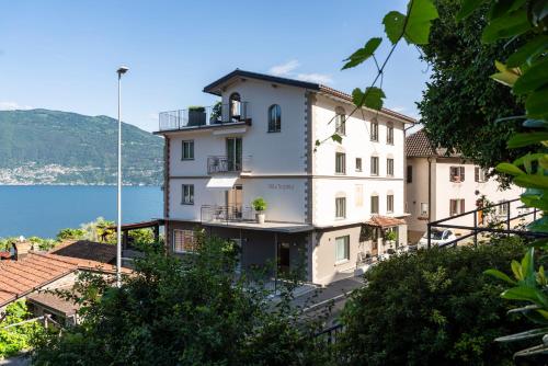 a large white building with a view of the water at Villa Sophia in Gerra