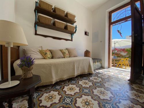 a living room with a bed and a window at At Fourth in Cagliari
