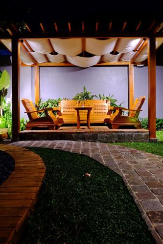 a group of chairs and a couch on a patio at O.B oemah bone homestay in Sanur