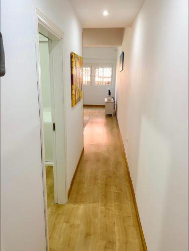 a hallway with white walls and a wooden floor at Edificio Rambla Pulido in Santa Cruz de Tenerife