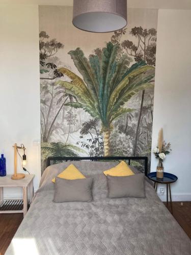 a bedroom with a large bed with a painting on the wall at La villa Bherte dé cil in Aire-sur-lʼAdour