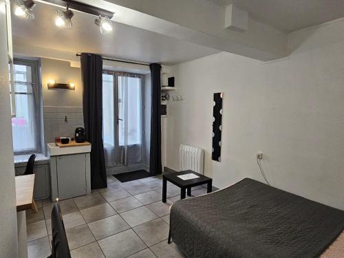 ムン・シュル・ロワールにあるMeung sur Loire sur la route des Châteauxのベッドルーム1室(ベッド1台付)、キッチン、テーブルが備わります。