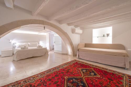 a bedroom with two beds and a red rug at Casa Scina' in Syracuse