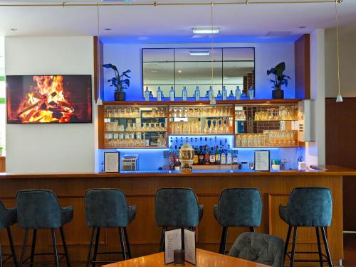 a bar in a restaurant with chairs around it at Acron-Hotel Quedlinburg in Quedlinburg