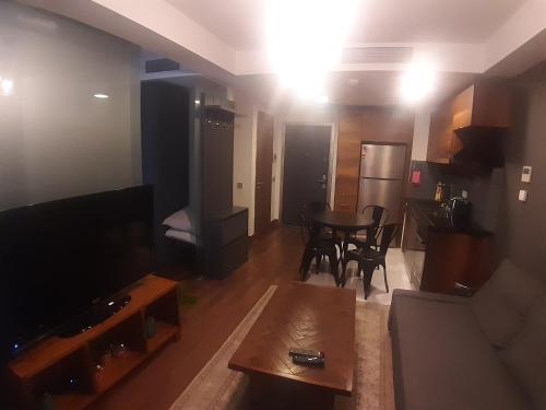 a living room with a television and a table at Motivaada Rezidans in Istanbul