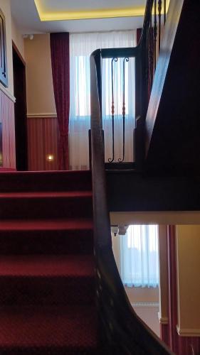 a view of a staircase in a building with red carpet at Hotel Dvorana in Karlovy Vary