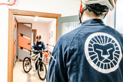 a person riding a bike in a hallway at Le Lion Apartments - Bike & Ski in Aosta
