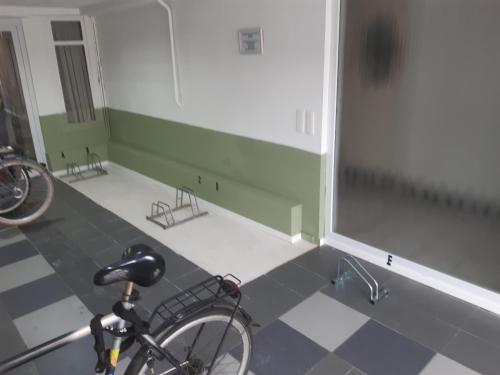 a bike parked in a room with a tiled floor at Casa ENRICO in Antwerp
