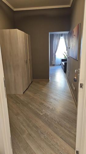 an empty living room with a hard wood floor at PRIMA FILA DUE Pemium Guest House in Sanremo