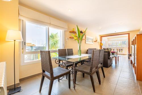 a living room with a dining room table and chairs at Mimosa in Alcudia