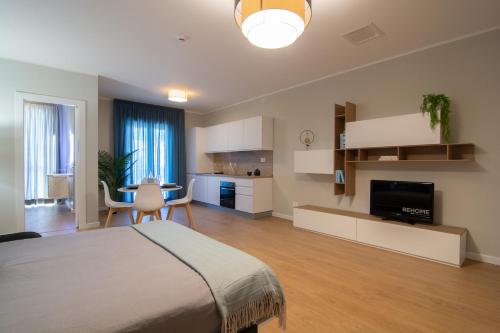 a large bedroom with a bed and a kitchen at Itinera Home Residence in Montalto Uffugo