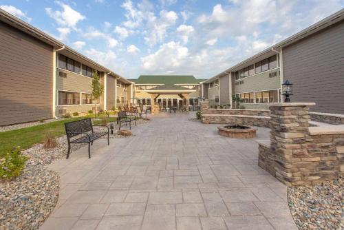 a courtyard of a building with benches and benches at Wyndham Garden Fort Wayne in Fort Wayne
