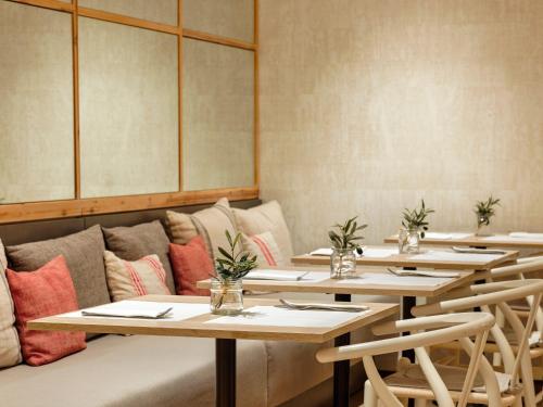 a row of tables in a restaurant with a couch at Musik Boutique Hotel in Barcelona