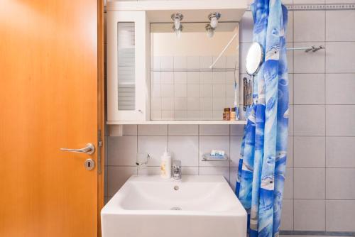a bathroom with a sink and a mirror at Cretan View Apartments with sea view in Stavros