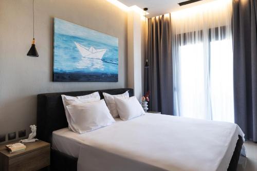 een slaapkamer met een bed met een papieren boot erop bij Helios Blue Villas Kassandra in Kriopigi