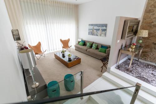 a living room with a couch and a table at Quinta da Terrincha in Torre de Moncorvo
