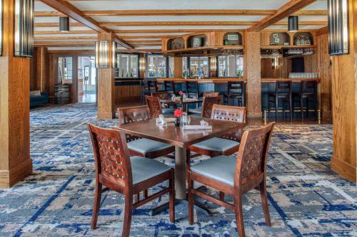 a dining room with a wooden table and chairs at DoubleTree by Hilton Hotel Burlington Vermont in Burlington