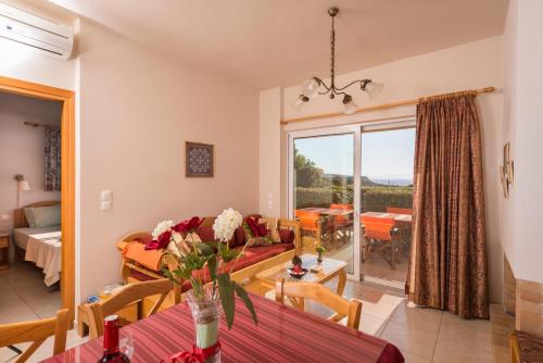 a living room with a couch and a table at Cretan View Apartments with sea view in Stavros