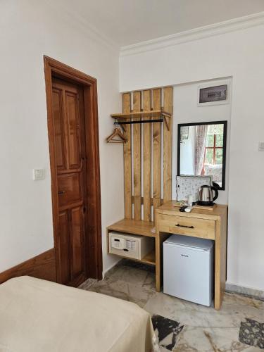 a bedroom with a bed and a desk and a mirror at Sibel Hotel in Antalya
