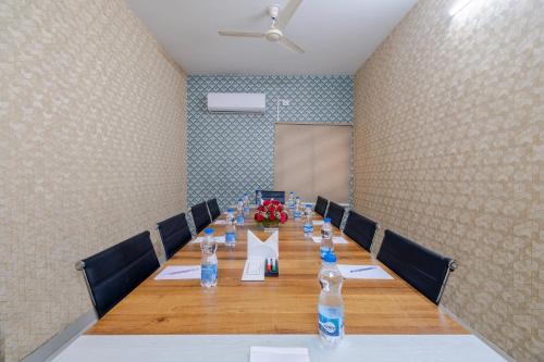 a conference room with a long table with bottles of water at Lemonridge Hotels Kukatpally in Hyderabad