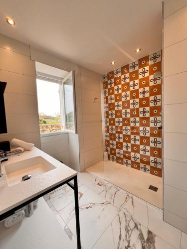 a bathroom with a shower and a sink and a mirror at Santateresa in Bonifacio