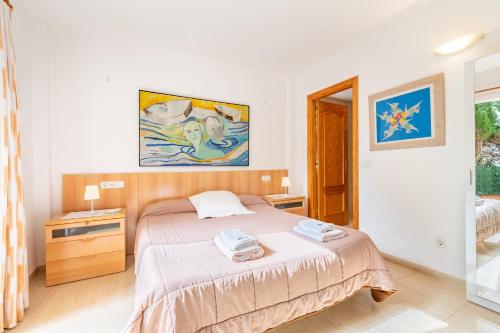 a bedroom with a bed with two towels on it at Apartamento Olot in Pollença