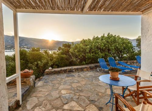 a patio with chairs and a table with a view at Elounda Island Villas in Elounda