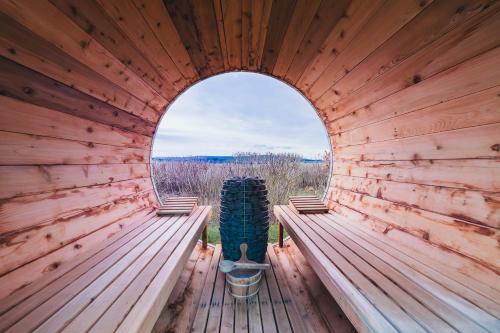 an inside view of a wooden cabin with a window at Hunsrück Valley View Apartment with Cedar SAUNA in Bruschied