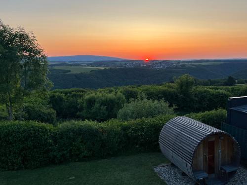 a view of the sunset from a roof of a house at Hunsrück Valley View Apartment with Cedar SAUNA in Bruschied