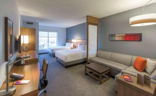 a large hotel room with a bed and a couch at DoubleTree by Hilton Asheville Downtown in Asheville