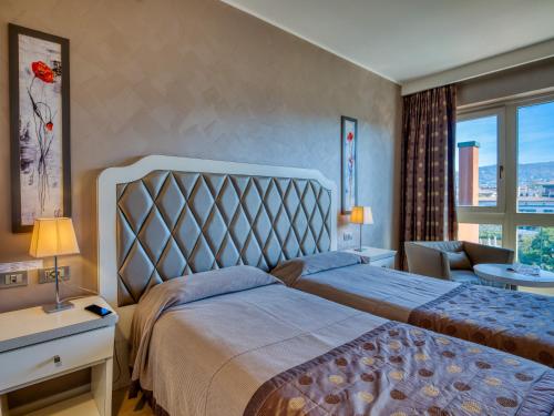 a hotel room with a bed and a window at Parc Hotel Gritti in Bardolino