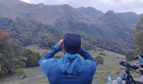 a man standing on top of a mountain looking at the mountains at Riu Nere Mountain Hotel in Vielha